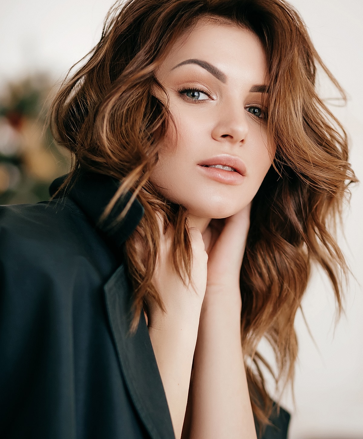 Woman with wavy hair in a stylish outfit.